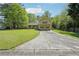 Charming two-story home with yellow siding, green shutters, and a large front yard at 1522 Sprayberry Dr, Marietta, GA 30066
