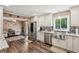 Open kitchen with stainless steel appliances, shaker cabinets, wood floors, and eat-in breakfast area at 1522 Sprayberry Dr, Marietta, GA 30066