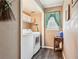 Laundry room featuring a washer and dryer, storage shelves, and wooden-look vinyl flooring at 1522 Sprayberry Dr, Marietta, GA 30066