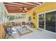 Comfortable sunroom features exposed beam ceiling, ceiling fan and sliding doors at 1522 Sprayberry Dr, Marietta, GA 30066