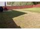 Spacious backyard with green grass, patio, and a dark stained wooden fence at 20 Autumn Canyon Se Path, Cartersville, GA 30121