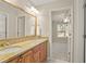 Bathroom with double sink vanity and large mirror with a view into another room at 439 Lake Point Trce, Canton, GA 30114