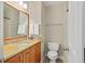 Well-lit bathroom featuring a granite countertop, vanity, and white toilet at 439 Lake Point Trce, Canton, GA 30114