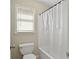 Bathroom featuring a tub and shower combination with a framed window at 439 Lake Point Trce, Canton, GA 30114