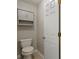 Powder room with toilet and storage cabinet with white door at 439 Lake Point Trce, Canton, GA 30114