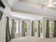 Primary bedroom with tray ceilings and large bay windows that offer lots of natural light at 439 Lake Point Trce, Canton, GA 30114