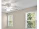 Bedroom featuring neutral walls, carpet flooring, and two windows with a view at 439 Lake Point Trce, Canton, GA 30114