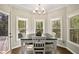 Charming breakfast nook with many windows, hardwood floors, and a view of the yard at 439 Lake Point Trce, Canton, GA 30114