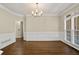 Formal dining room with wainscoting, hardwood floors, and chandelier at 439 Lake Point Trce, Canton, GA 30114