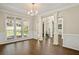 Bright dining room with hardwood floors, white trim, and large windows offering natural light at 439 Lake Point Trce, Canton, GA 30114