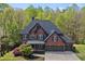 Stunning brick two-story home with a three-car garage and mature trees at 439 Lake Point Trce, Canton, GA 30114