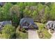 Stunning aerial view of a brick home with a three-car garage and beautifully landscaped yard at 439 Lake Point Trce, Canton, GA 30114
