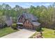 Stunning brick home with three-car garage, mature trees and lush landscaping at 439 Lake Point Trce, Canton, GA 30114