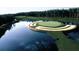 Scenic aerial shot of a golf course with a green island surrounded by a pond at 439 Lake Point Trce, Canton, GA 30114