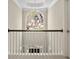 Upstairs hallway featuring a railing and a window letting in natural light at 439 Lake Point Trce, Canton, GA 30114