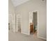 Hallway with open doorways to a walk-in closet and bathroom at 439 Lake Point Trce, Canton, GA 30114