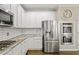 Modern kitchen with stainless steel appliances, granite countertops and white cabinets at 439 Lake Point Trce, Canton, GA 30114