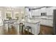 Bright kitchen with white cabinets, stainless steel appliances, and adjacent breakfast nook at 439 Lake Point Trce, Canton, GA 30114