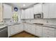 Well-lit kitchen with stainless steel appliances and subway tile backsplash at 439 Lake Point Trce, Canton, GA 30114