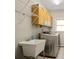 Functional laundry room with overhead cabinets, utility sink, and modern washer/dryer at 439 Lake Point Trce, Canton, GA 30114