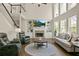 Cozy living room with fireplace, built-in shelving, and large windows for natural light at 439 Lake Point Trce, Canton, GA 30114