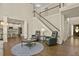 Open concept living area with staircase, hardwood floors and an adjacent modern kitchen at 439 Lake Point Trce, Canton, GA 30114