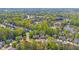Aerial view of lush neighborhood with pond, trees and homes at 4420 Thorngate Ln, Acworth, GA 30101