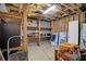 Unfinished basement showcasing wooden shelves, equipment, and exposed ceiling beams at 4420 Thorngate Ln, Acworth, GA 30101