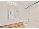 Bright, clean bathroom featuring a shower over tub and oak-trimmed vanity at 4420 Thorngate Ln, Acworth, GA 30101