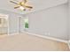Spacious bedroom with neutral carpet, ceiling fan, and attached bathroom access at 4420 Thorngate Ln, Acworth, GA 30101