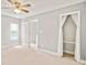Bright bedroom with beige carpet, ceiling fan, and closet at 4420 Thorngate Ln, Acworth, GA 30101
