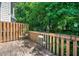 A wooden deck with a wooden fence, plants, and greenery at 4420 Thorngate Ln, Acworth, GA 30101