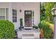 Inviting front door with sidelights and decorative plants creating a warm welcome at 4420 Thorngate Ln, Acworth, GA 30101