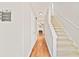 Bright hallway featuring hardwood floors and staircase leading to the upper level at 4420 Thorngate Ln, Acworth, GA 30101