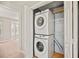Efficient laundry closet with stacked washer and dryer unit and wire shelving at 4420 Thorngate Ln, Acworth, GA 30101