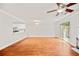 Spacious living room with hardwood floors, ceiling fan and sliding door to the backyard at 4420 Thorngate Ln, Acworth, GA 30101