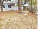 The backyard is adorned with a charming wishing well adding character to the outdoor space of this quaint home at 1895 Thomasville Se Dr, Atlanta, GA 30315