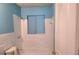 Bathroom featuring tiled walls, a toilet, a shower and a blue painted wall at 1895 Thomasville Se Dr, Atlanta, GA 30315