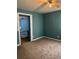 Bedroom featuring carpeted floor and a view of the blue-walled hallway at 1895 Thomasville Se Dr, Atlanta, GA 30315
