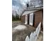 Side view of a brick house exterior featuring white trim and a white picket fence at 1895 Thomasville Se Dr, Atlanta, GA 30315