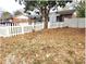 Quaint brick home featuring a classic white picket fence and a mature tree providing shade and character at 1895 Thomasville Se Dr, Atlanta, GA 30315