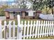 Charming brick house with a white picket fence and well-maintained lawn, offering a welcoming curb appeal at 1895 Thomasville Se Dr, Atlanta, GA 30315