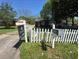 A cozy home with a white picket fence and a 'For Sale' sign in the front yard at 1895 Thomasville Se Dr, Atlanta, GA 30315