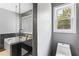 Modern bathroom with glass shower, soaking tub, and elegant dark marble tile at 2077 Alcovy Trace Way, Lawrenceville, GA 30045