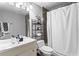 Full bathroom with vanity, shelving unit, and shower featuring modern fixtures at 2077 Alcovy Trace Way, Lawrenceville, GA 30045