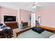 Pink bedroom with a mix of furniture styles, including a dresser, bench, and a visible doorway at 2077 Alcovy Trace Way, Lawrenceville, GA 30045