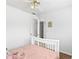 Inviting bedroom with a white frame bed, and ceiling fan for comfort at 2077 Alcovy Trace Way, Lawrenceville, GA 30045