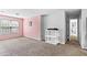 Large bedroom with neutral walls and a view of the exterior, featuring pink and gray walls at 2077 Alcovy Trace Way, Lawrenceville, GA 30045