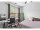 A comfortable bedroom with a well-lit desk area by the window, providing an ideal space for work or study at 2077 Alcovy Trace Way, Lawrenceville, GA 30045