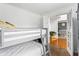 Bedroom featuring a gray bunk bed with views of the dining room through open French doors at 2077 Alcovy Trace Way, Lawrenceville, GA 30045